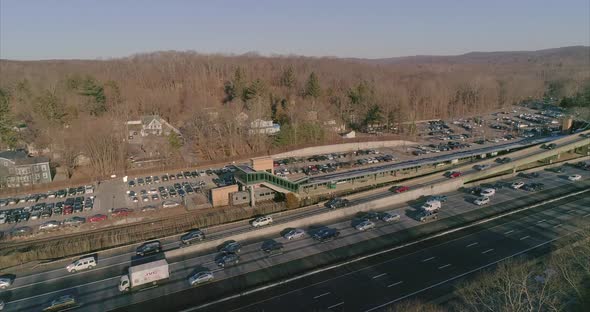 A busy highway and train station during early morning rush hour alt