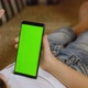 Child Uses Mobile Phone Green Screen To Scroll Internet Pages of News Messages. - VideoHive Item for Sale