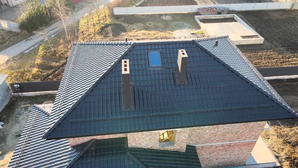 Aerial View of House Roof Top Covered with Ceramic Shingles alt