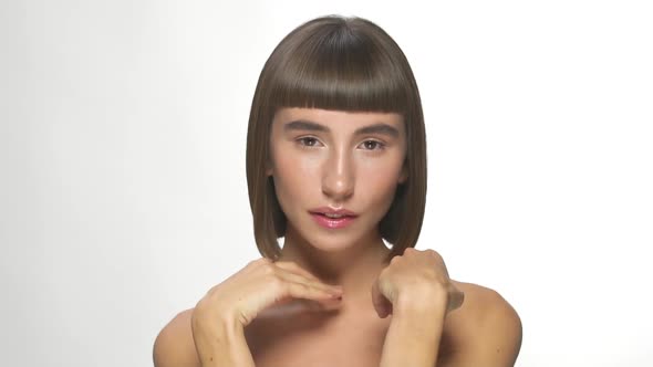 Beautiful Woman with Straight Short Hairstyle and Naked Shoulders Posing alt