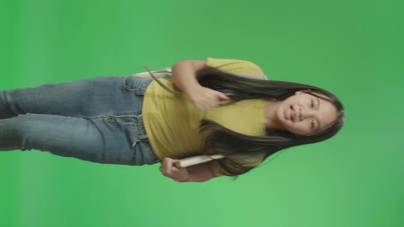 Asian Girl Student Holding Book While Running To School On Green Screen Chroma Key alt