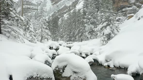 jib up of calm creek in snow covered landscape alt