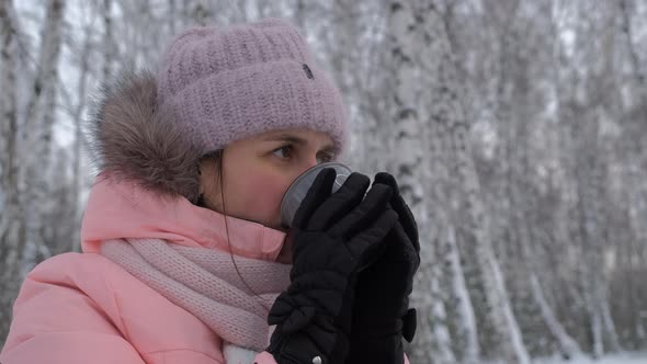 Young Woman Drinking Hot Tea in Cold Winter Day alt