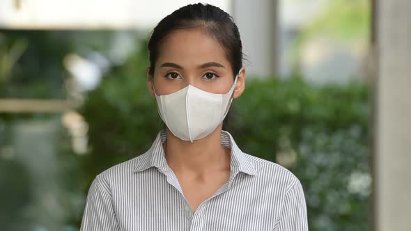 Asian Woman Wearing Face Mask to Protect From Coronavirus Covid19