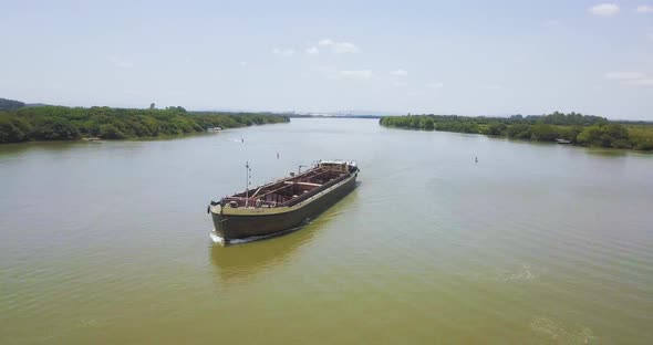 Large Barge traveling down Jacui River, Brazil. Wide Aerial Pan View alt