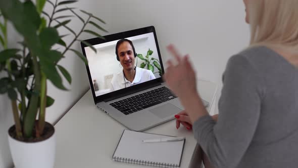 Back View of Business Woman Talking to Her Colleagues About Plan in Video Conference alt