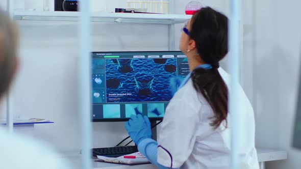Scientist Nurse Typing on Computer in Scientific Laboratory alt