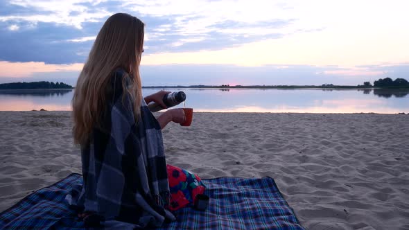 Beautiful Girl Drinking Coffee On The Beach In The Morning