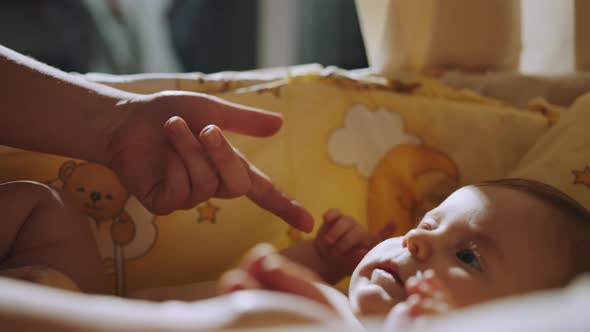 Close Up Shot of Baby's Little Cute Hand Reaching for Father's Loving Finger alt