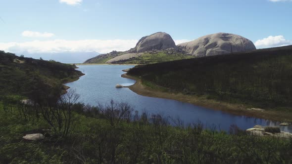 Aerial - Flying towards beautiful dam on Paarl Mountain, with imposing granite monolith in backgroun alt