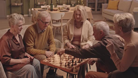 Senior People Playing Chess at Friends Dinner alt