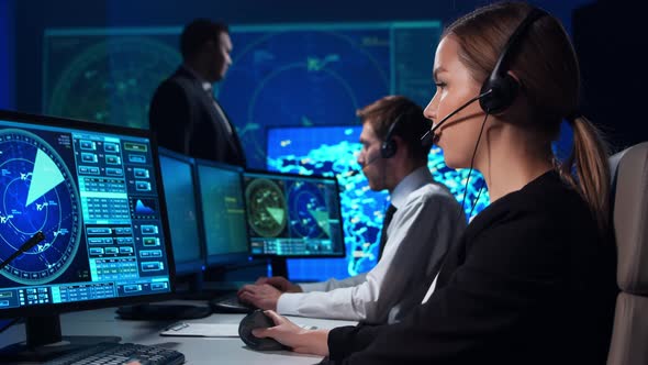 Workplace of the air traffic controllers in the control tower. Team of professional officers. alt