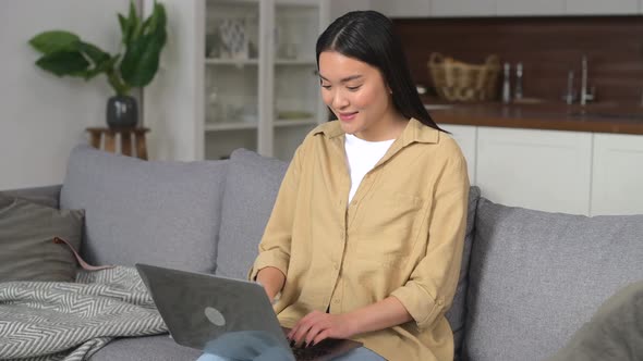 Asian Young Woman Spending Home Leisure with Laptop