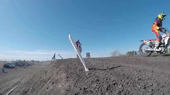 Men racing in a motocross motor sports race. alt