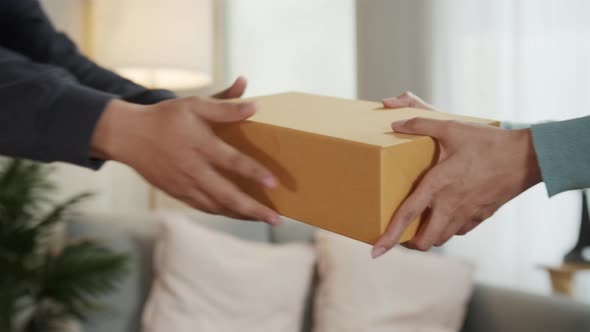 Close up of Asian Woman Hand Receive a parcel cardboard box