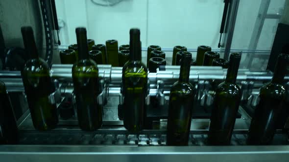 Conveyor with Wine Bottles at Wine Factory White Wine Production Bottle Washing and Filling alt