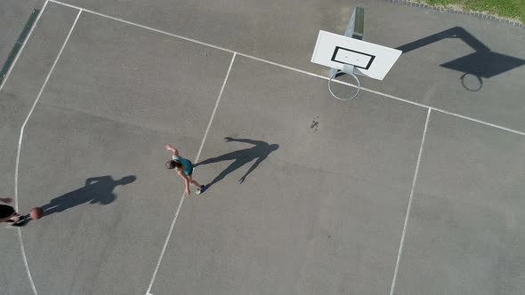 Man and woman shooting basketball on the court alt