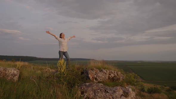 Girl Raises Her Hands Up and Cherfully Smiling alt