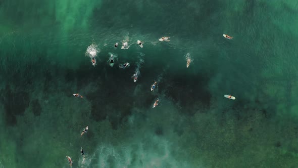 Aerial Top Down Drone View at Surfers on the Wave Bali Indonesia alt