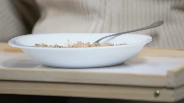 Wrinkled Aged Lady Looking With Disgust at Unappetizing Porridge in Nursing Home alt