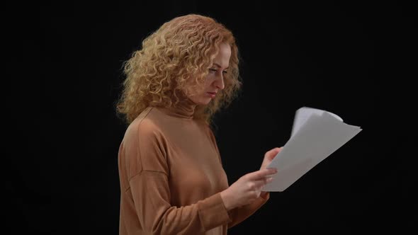 Nervous Caucasian Woman Throwing Away Paperwork Rehearsing Speech at Black Background alt