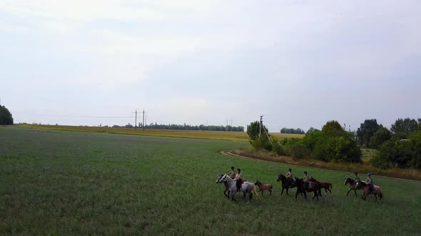 Group Of Horseback Riders. Group of young horseback riders riding in countryside alt
