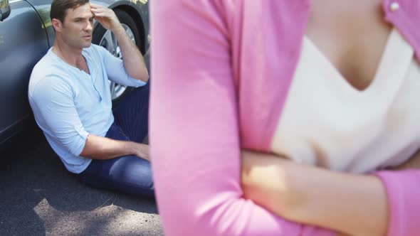 Couple ignoring each other near car alt