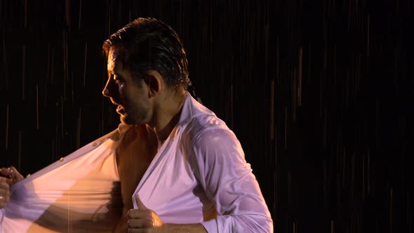 Young Man Sexy Dancing in Rain in an Unbuttoned White Shirt alt