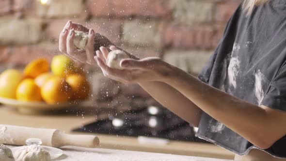 Cook Juggles with Raw Dough in Kitchen