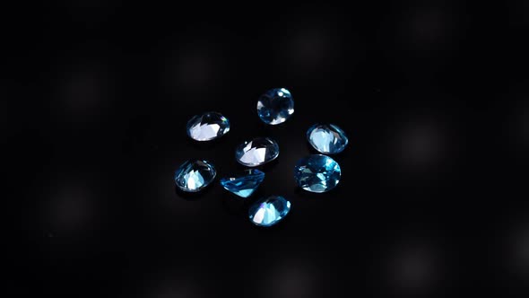 Natural Blue Topaz Gemstones on the Dark Background Turning Table