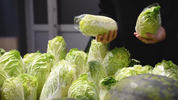Woman Choose Chineese Cabbage in Grocery Store alt
