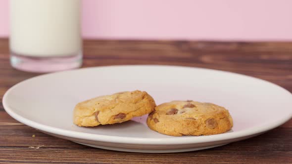 Close Up of a Woman Laying Cookies on a Plate to Eat