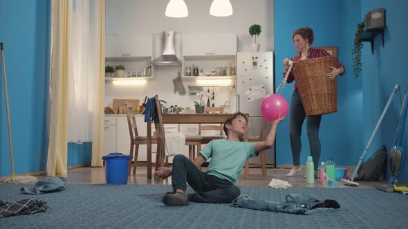 Housewife Holds a Basket of Laundry alt