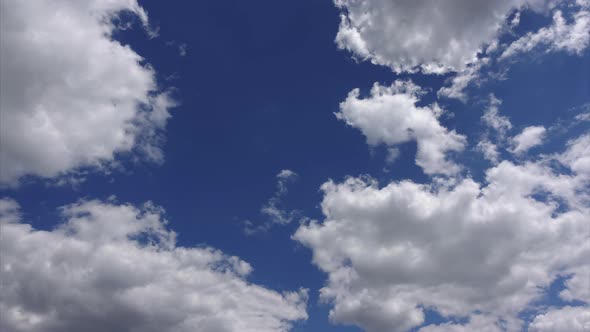 Beautiful cloudscape, Timelapse 4K. Amazing white clouds in the blue sky in sunlight alt