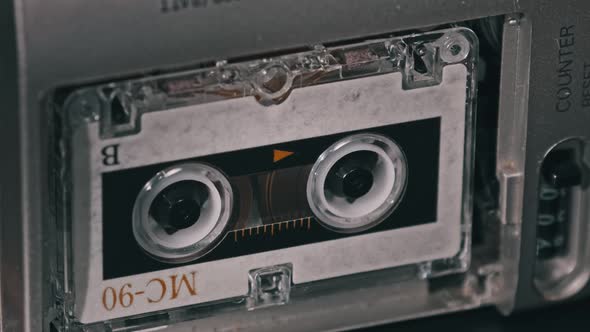 Audio Cassette in the Tape Recorder Playing and Rotates alt