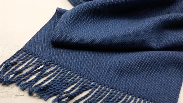 Blue woven or knitted cloth. Surface of the draped shawl or scarf. Fiber and fabric structure