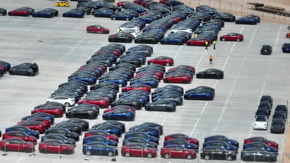 Brand new Tesla Model Y cars manufactured at Giga Texas. Aerial reveal of factory parking lot in Aus alt