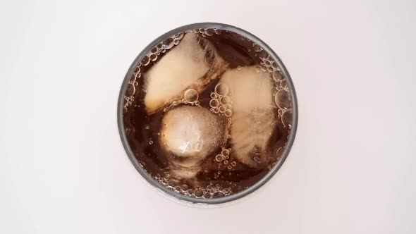 ice tea pouring into the glass with ice cubes