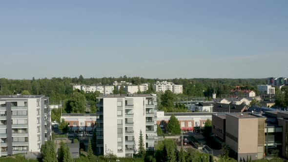 Quick rising aerial view of a small river and train station in a Finnish city near Helsinki. alt