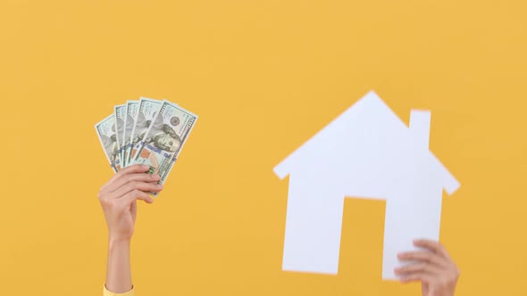 Hands holding US dollar money with house model for buying new house concept