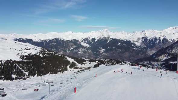 Aerial View of the Alps Mountains in France. Mountain Tops Covered in Snow. Alpine Ski Facilities