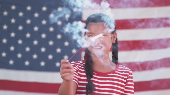 Girl waving sparkler on Fourth of July