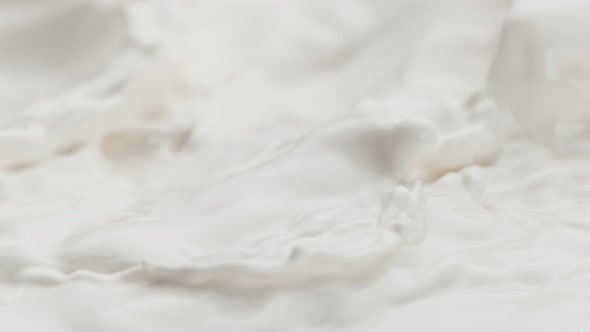 Super Slow Motion Detail Shot of Splashing Fresh Milk at 1000 Fps alt