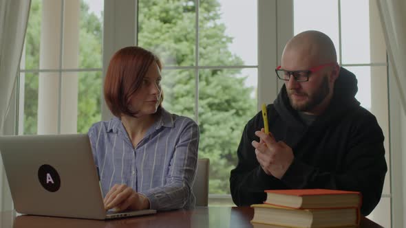 Wife Working Online Using Laptop Husband Using Mobile Phone alt