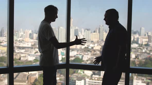 Businessmen Meeting in Front of Panoramic Window