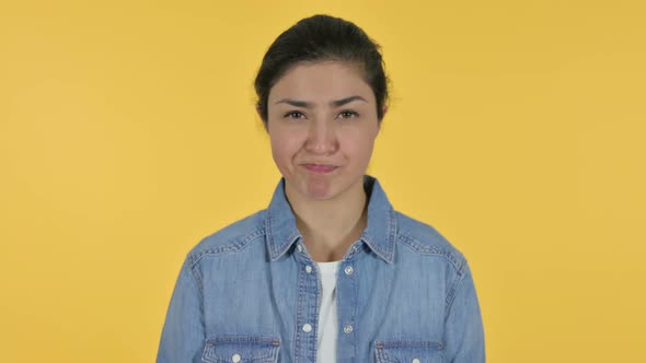 Indian Woman Shaking Head As No Sign, Yellow Background  alt
