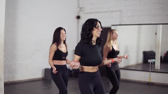 Group of Three Attractive Women Learning Bachata Basic Moves alt