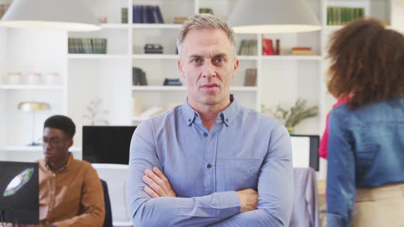 Business man smiling at the camera alt