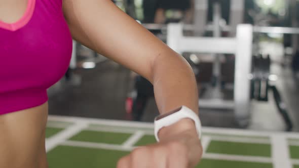 Asian healthy sport woman wearing smartwatch device check heart rate result after workout.