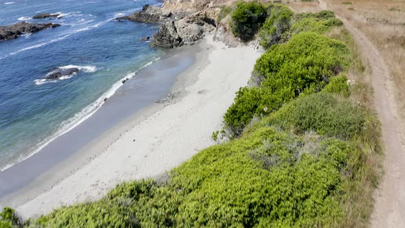 Aerial push in over the cliffs of Sea Ranch, California alt
